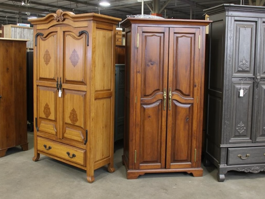 A showroom with various armoires, from rustic wood to modern metal.
