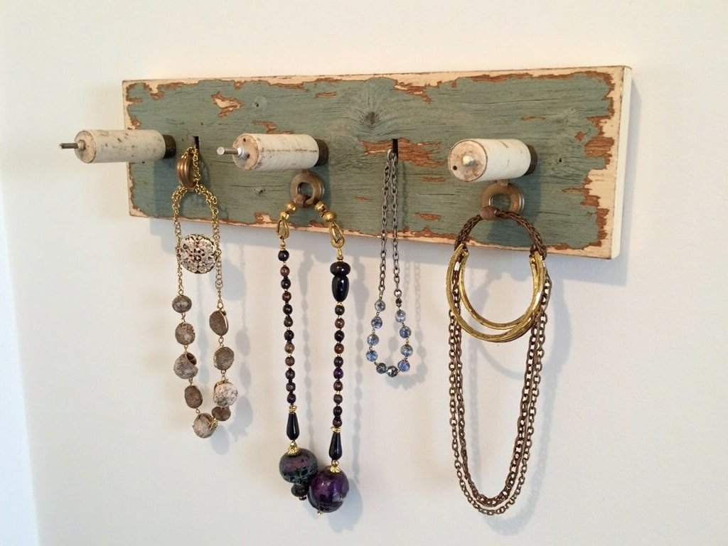 A creative DIY jewelry organizer made from repurposed materials.